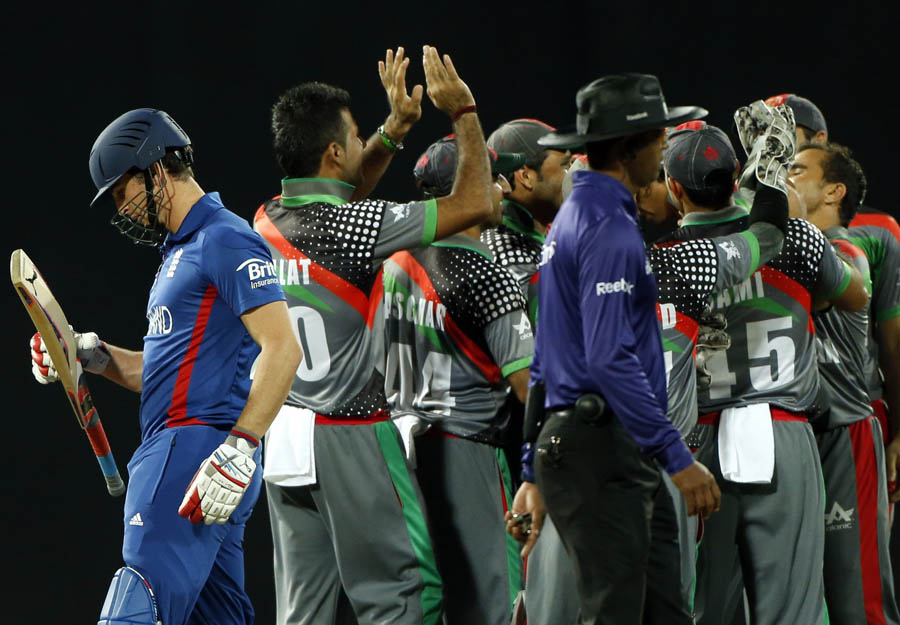 Craig Kieswetter, left, leaves the pitch after his dismissal