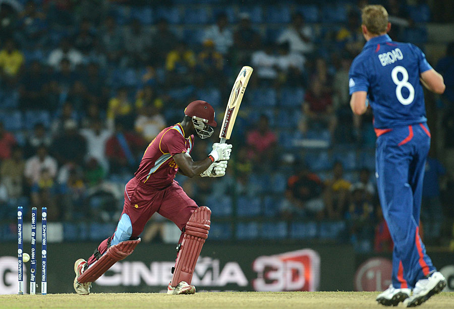 Darren Sammy swings and Stuart Broad hits the stumps