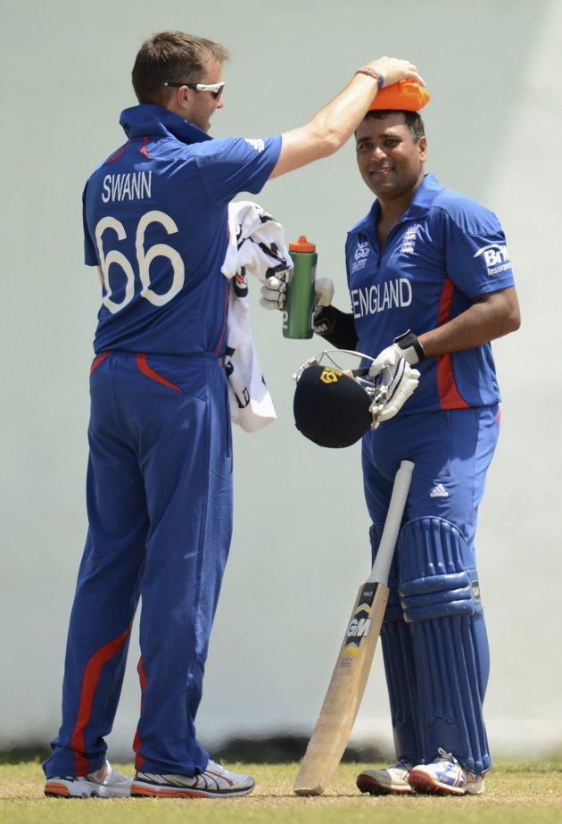 England's Samit Patel has an ice pack held on his head by Graeme Swann (L) during a warm-up match