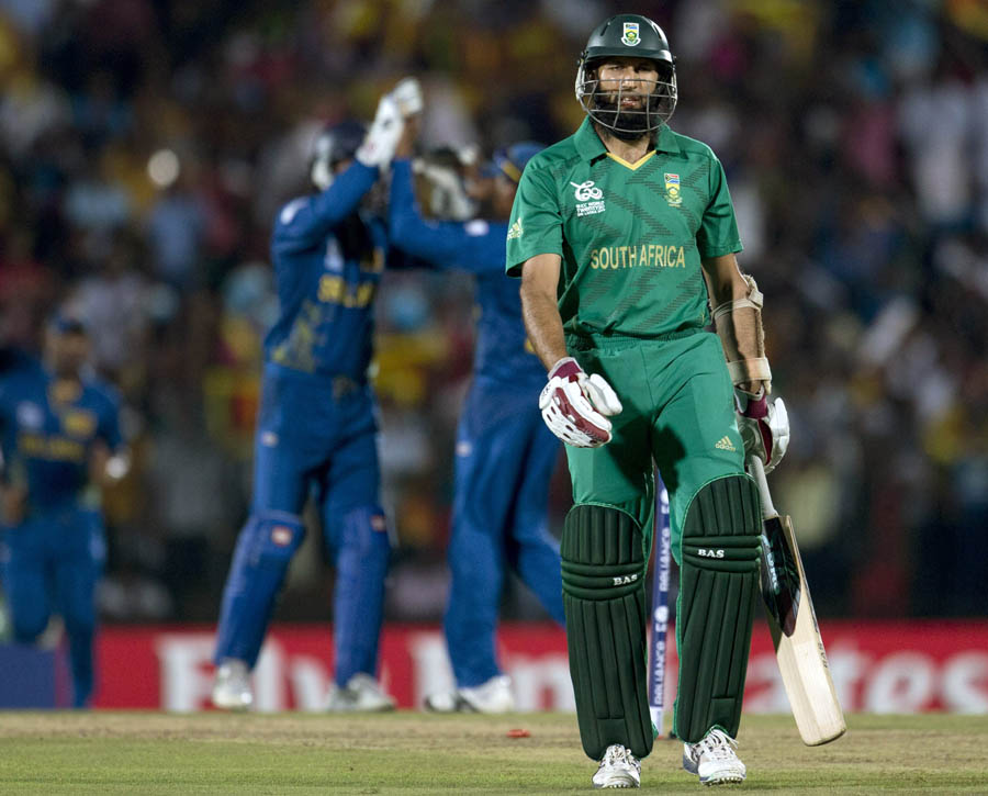 South Africa's Hashim Amla, right, walks back to the pavilion