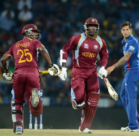Johnson Charles and Chris Gayle cross as Jade Dernbach looks on Johnson Charles and Chris Gayle cross as Jade Dernbach looks on