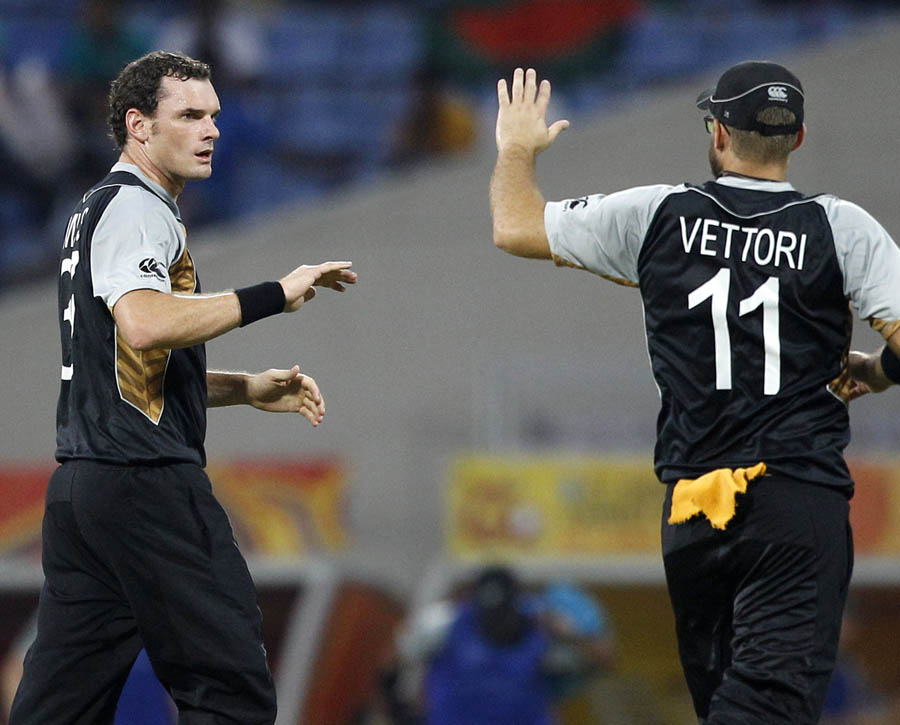 Kyle Mills, left, celebrates with teammate Daniel Vettori after taking the wicket of Bangladesh's batsman
