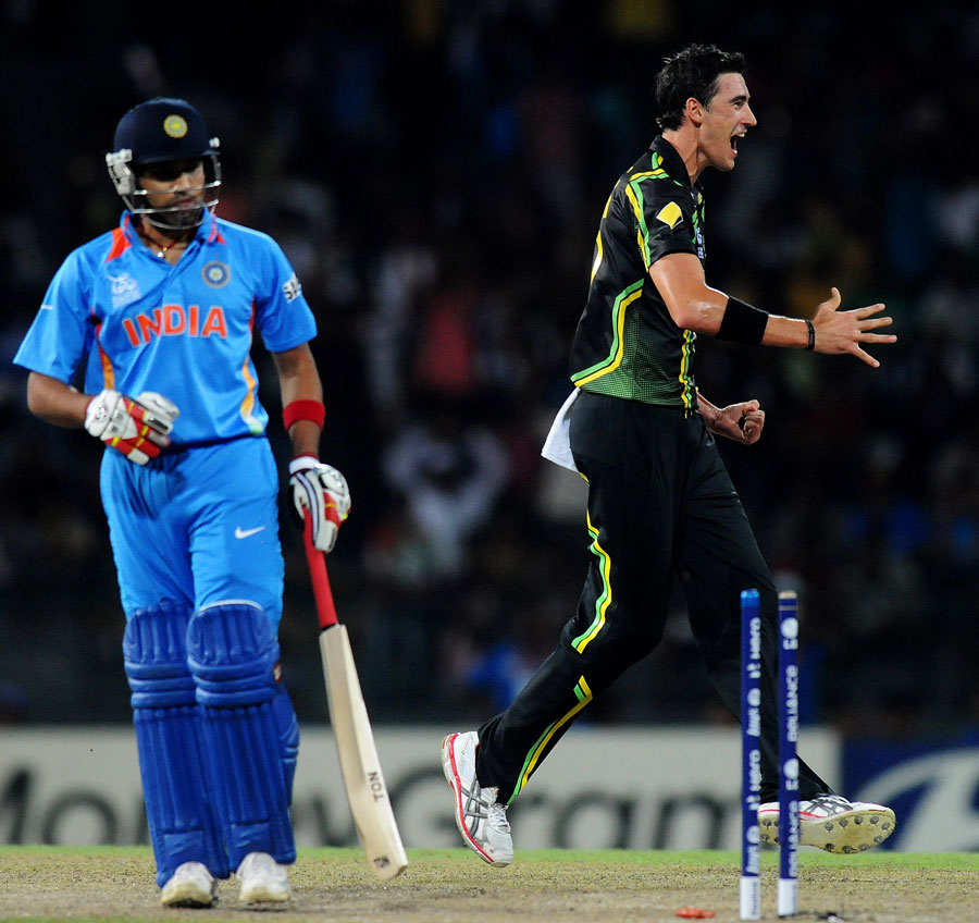 Mitchell Starc celebrates at knocking out Rohit Sharma's off stump