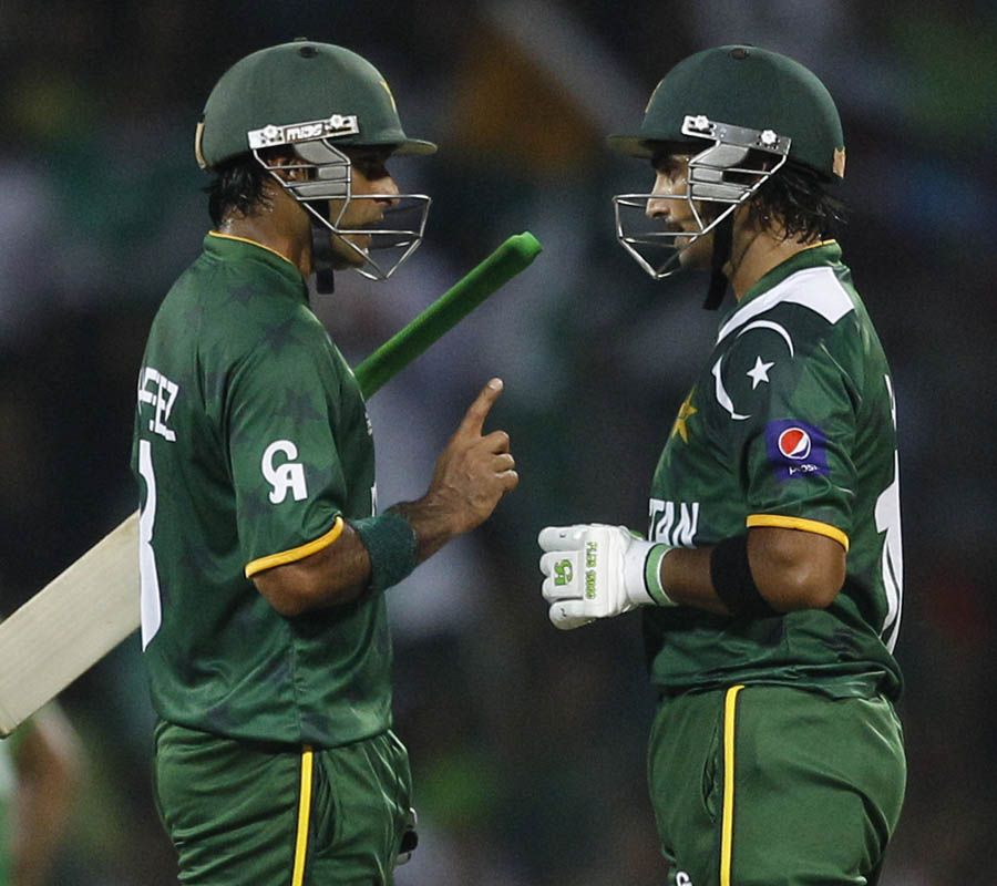 Pakistan's captain Mohammad Hafeez, left, talks to fellow batsman Imran Nazir 