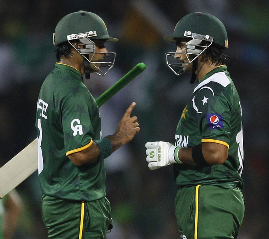Pakistan's captain Mohammad Hafeez, left, talks to fellow batsman Imran Nazir