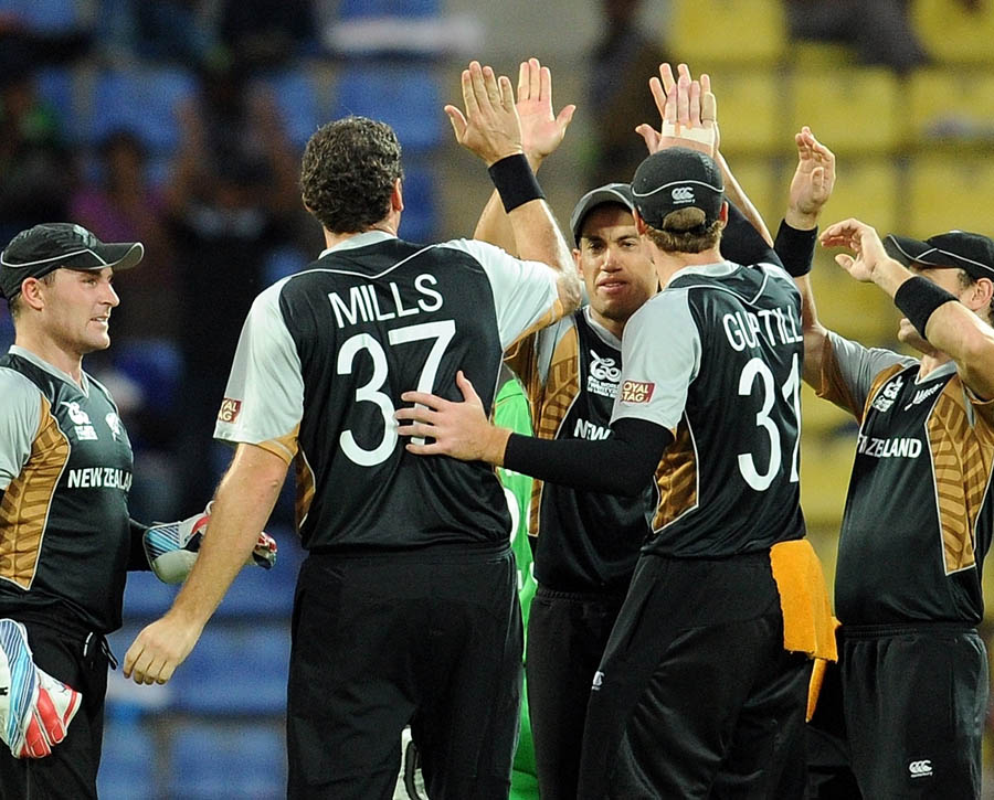New Zealand cricketers celebrate the wicket of unseen Bangladesh batsman Tamim Iqbal