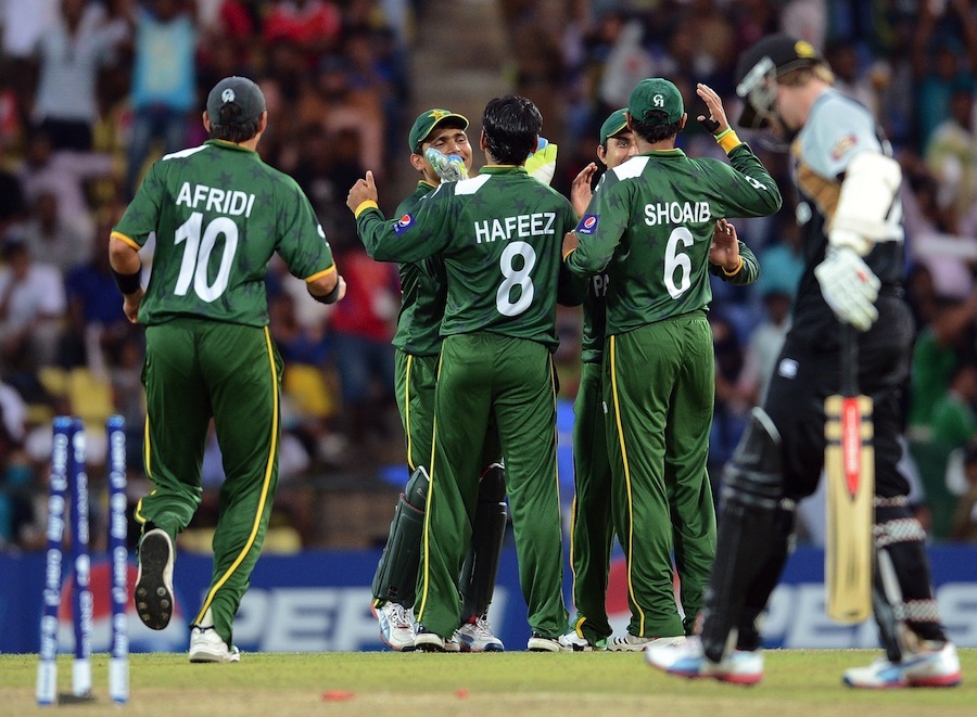 Pakistan cricketers celebrate the run out of New Zealand batsman Kane Williamson (R)