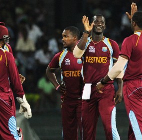 West Indies cricketer Darren Sammy (2R) celebrates after he dismissed Ireland cricketer Paul Stirling