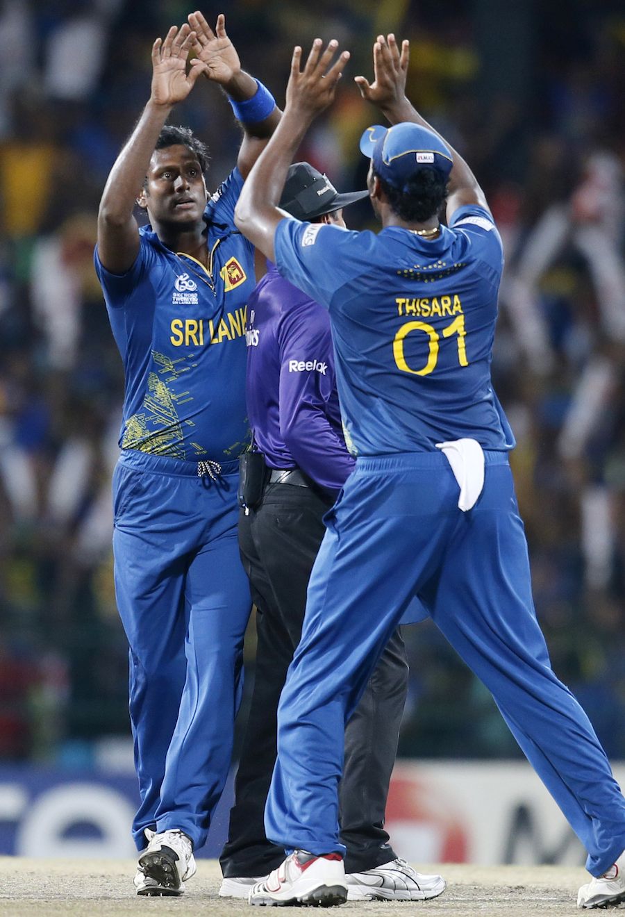 Angelo Mathews, left celebrates the dismissal of West Indies's 