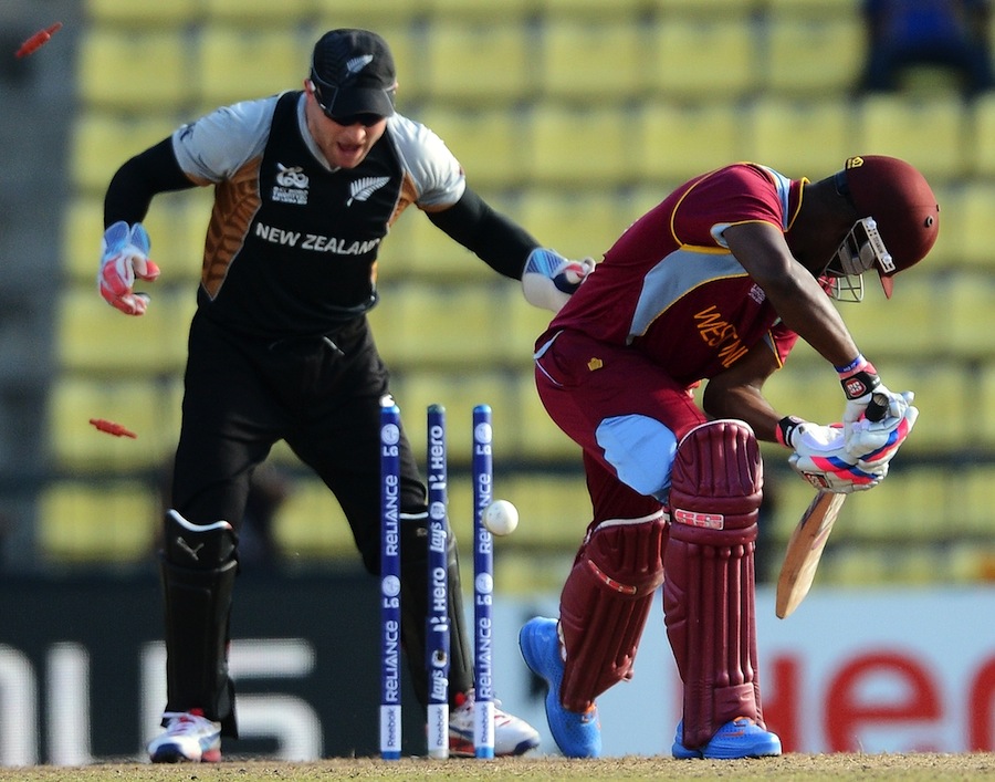 Brendon McCullum (L) celebrates the clean bowl of West Indies cricketer Darren Bravo (R) by Nathan McCullum