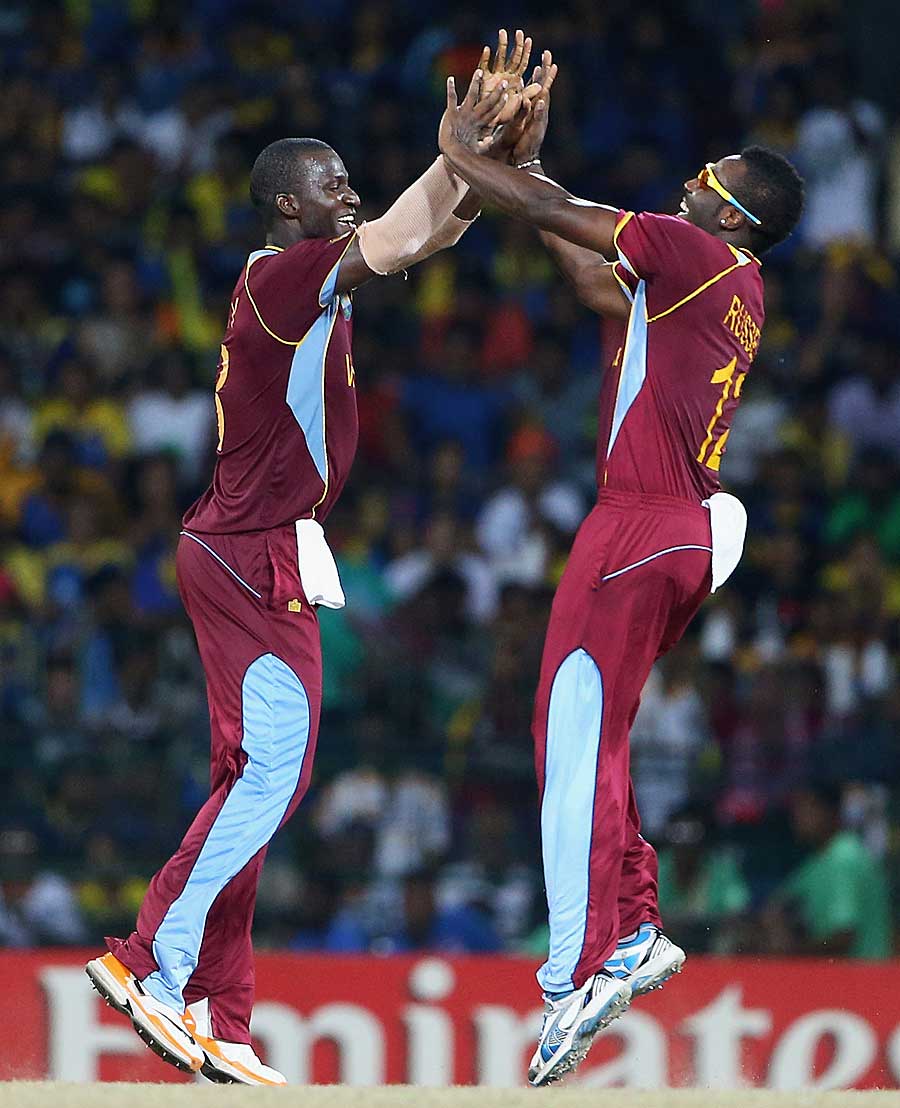 Darren Sammy and Andre Russell celebrate a wicket
