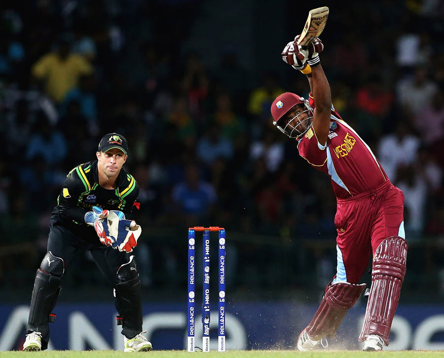 Dwayne Bravo of the West Indies hits a four, as Matthew Wade of Australia looks on during the ICC World Twenty20 2012 Semi Final