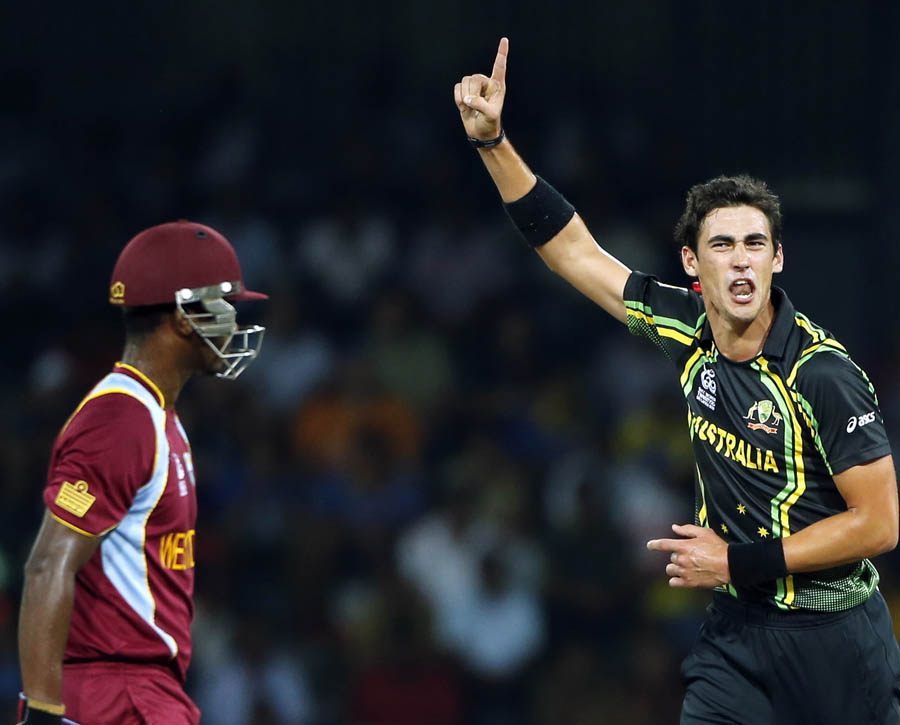 Australia's bowler Mitchell Starc , second right, celebrates taking the wicket of West Indies' batsman Johnson Charles