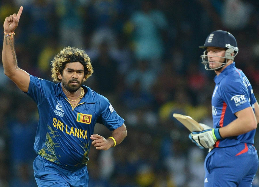 Lasith Malinga (L) celebrates the wicket of England's Jos Buttler (R) 