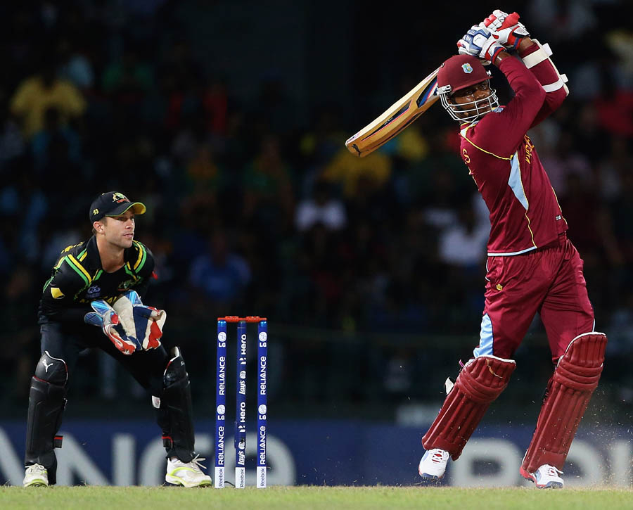 Marlon Samuels of the West Indies hits a six, as Matthew Wade of Australia