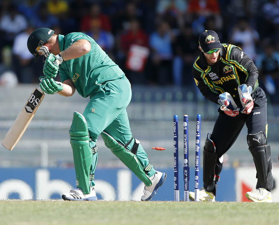 South Africa's batsman Richard Levi, left, is bowled out by Australia's bowler Xavier Doherty