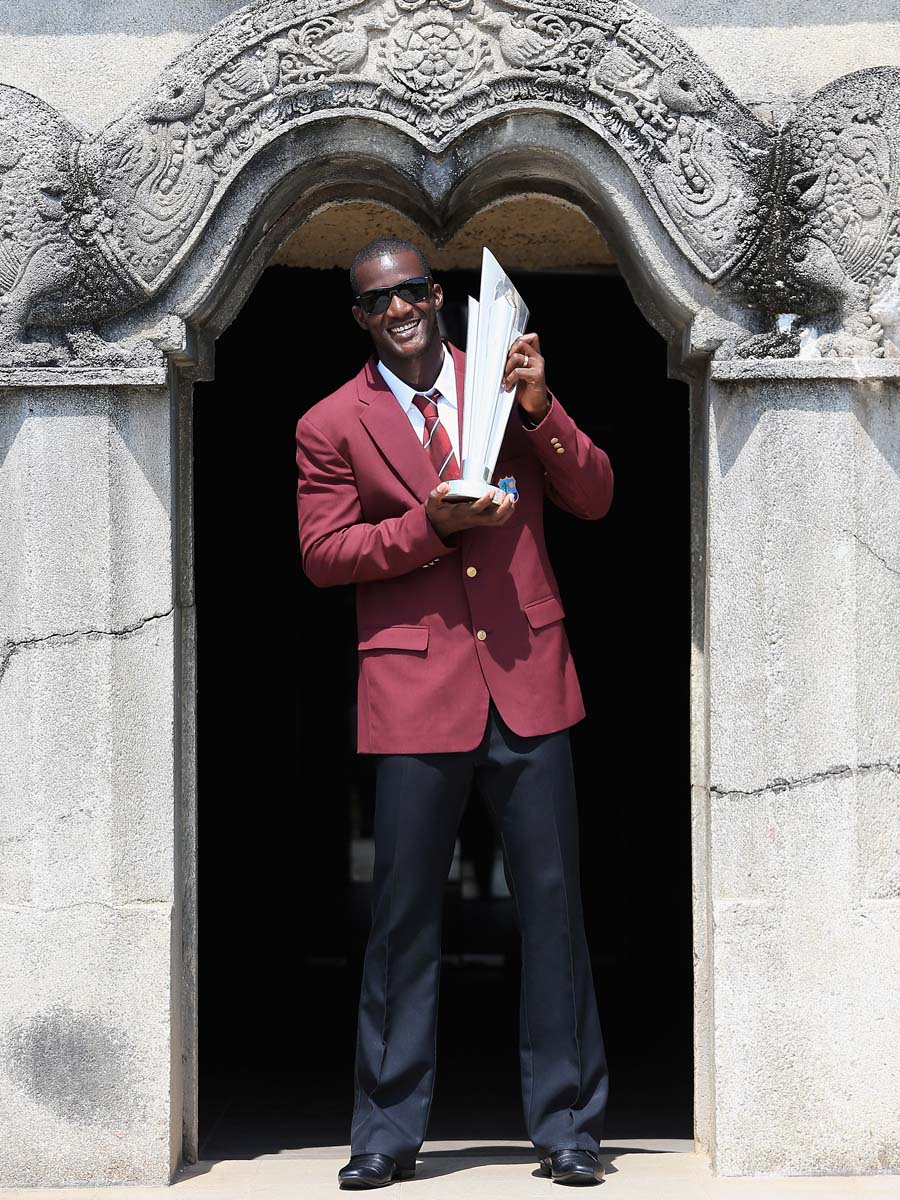 Darren Sammy, captain of the West Indies Cricket team poses for a photograph with the ICC World T20 Trophy at Independence Square