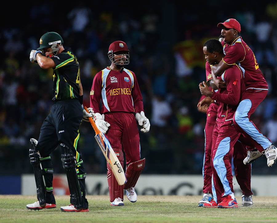 Dwayne Bravo of the West Indies congratulates Marlon Samuels, after he caught and bowled Michael Hussey